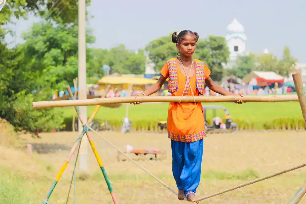 Adult and child practicing a balancing act together